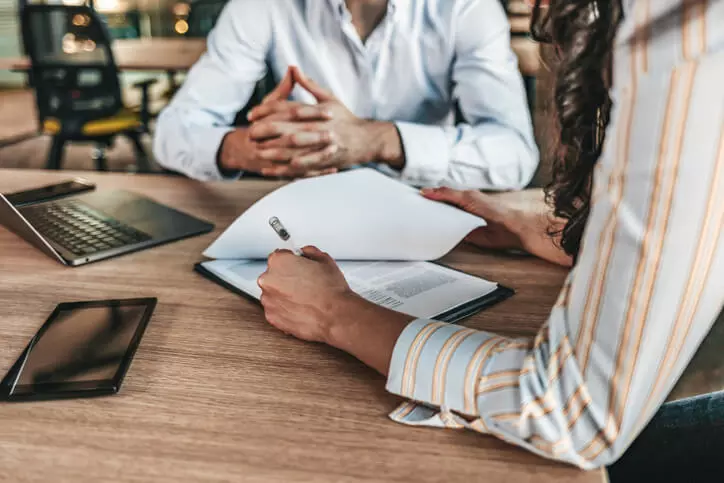 Debt Collection lawsuit attorney sitting with business owner client